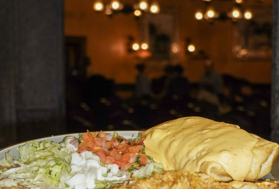 A cheese-covered burrito served at Don Señor Mt. Sterling with the warmly lit dining room in the background