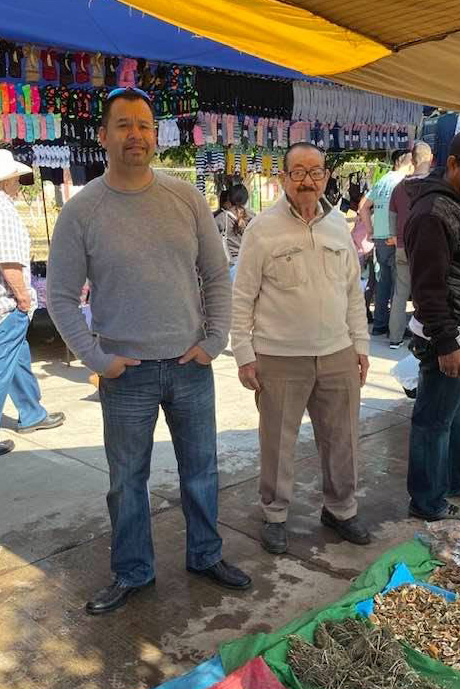 The father who inspired the Don Señor name visiting a traditional market with his son