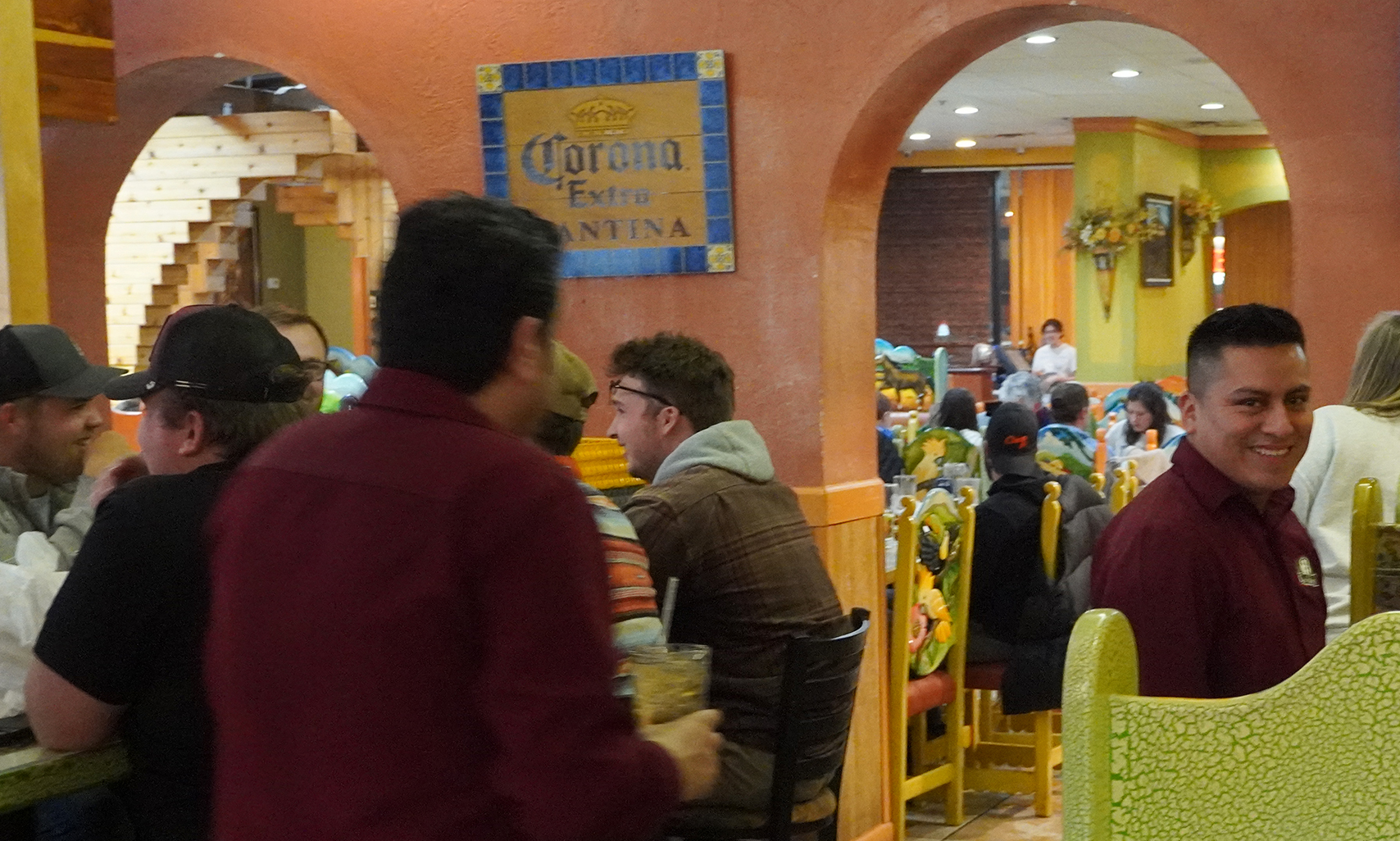 A smiling Don Señor Winchester server welcoming guests